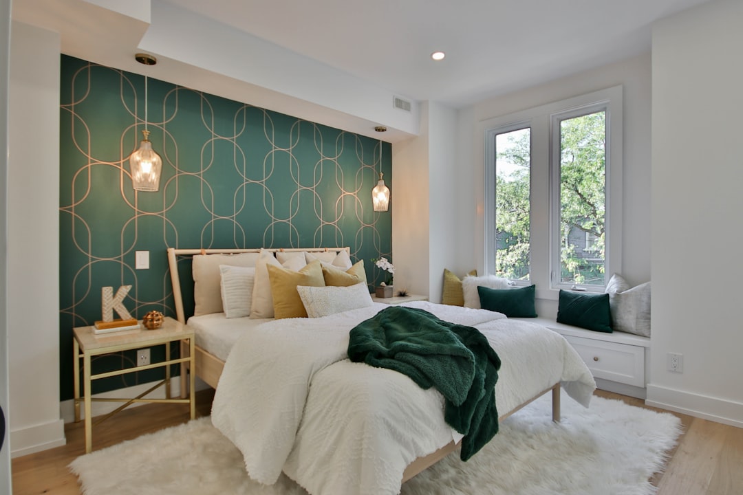 white bed linen near green plant